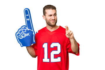 Wall Mural - sports fan man over isolated chroma key background with fingers crossing and wishing the best