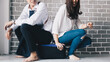© themorningglory - Happy couple sitting onluggage in new room moving to a new home