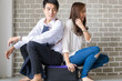 © themorningglory - Happy couple sitting onluggage in new room moving to a new home