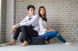© themorningglory - Happy couple sitting onluggage in new room moving to a new home
