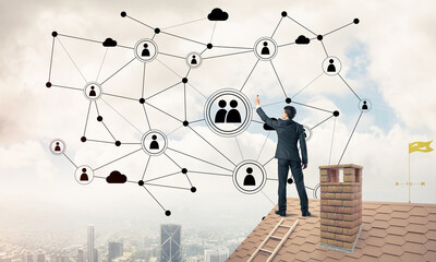 Wall Mural - Businessman on house roof presenting networking and connection c