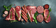 A set of juicy raw steaks, kebabs, cutlets and meat with spices and herbs. On a black stone background. Top view.