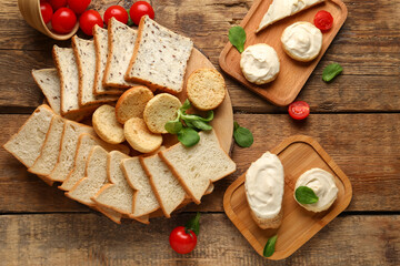 Sticker - Boards of fresh bread and tasty croutons with cream cheese on wooden background