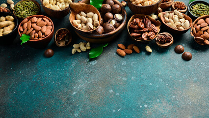 Wall Mural - Assorted shelled nuts: walnuts, cashews, hazelnuts, Brazil nuts, almonds. Close up, macro. Assortment of shelled nuts. Side view. on the texture table.