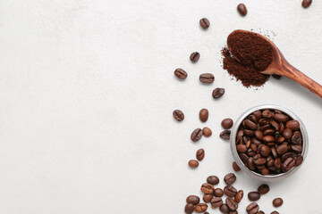 Wall Mural - Bowl with coffee beans and powder on light background