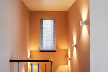 Modern interior of new entrance in residential building, apartment with Wooden Stair and window.