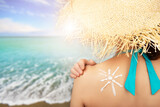 Fototapeta  - Middle aged caucasian female model applying sunscreen.
