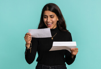 Pretty indian woman open envelope take out letter reads it feel happy. Hindu girl career growth advance promotion, bank loan approve, monetary award, long-awaited invitation great news, lottery win