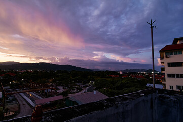 Wall Mural - Dramatic landscape with view on evening city. Beautiful cloudy sky.