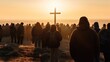 multitude of people  looking towards a cross on the horizon
