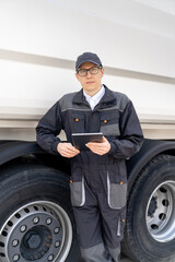 Poster - Manager with a digital tablet next to garbage truck..