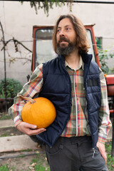 Poster - Adult bearded farmer with pumpkin