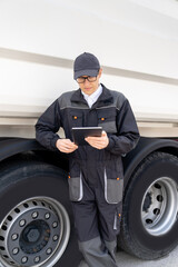 Poster - Manager with a digital tablet next to garbage truck..