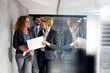 © Novak - Business colleagues walking inside a business building