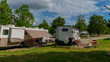 Rv motorhome camping sunny day trees clouds and grass