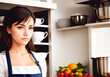 © Anton Dios - A beautiful young woman in an apron cooks in the kitchen. Generative AI