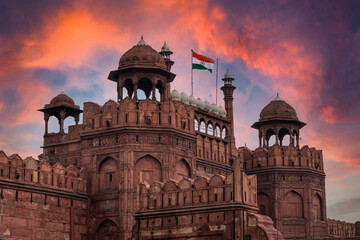 Wall Mural - Red Fort or Lal Qila in Delhi with indian flag on foreground with moody sk.UNESCO World heritage site. Discover the India. Open world after covid-19