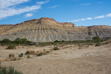 Poster - Abandoned barn at the foot of a large cliff in the Capitol Reef National Park, Utah