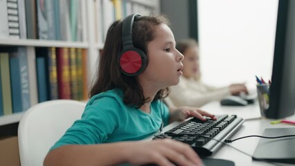 Canvas Print - Adorable girls students listening to music dancing at classroom