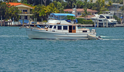 Wall Mural - A Vintage Motor Yacht leisurely cruising off Miami Beach on the Florida Intra-Coastal Waterway.