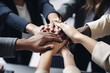 © Jasmina - Diverse team of businesspeople joining their hands together in unity, coming together in success.