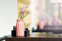 Small Flowers Of Pink, White And Yellow Flowers Stand In A Vase On The Table Of A Street Restaurant