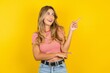 © Roquillo - Photo of attractive Young beautiful woman wearing striped t-shirt over yellow background direct finger empty space cheap dentistry