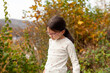 © PeterPike - Little girl with glasses on the background of the autumn forest. Back view.