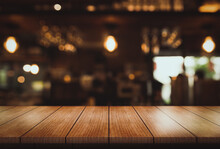 Empty Wooden Table Top With Lights Bokeh On Blur Restaurant Background.