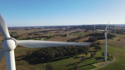 Wall Mural - aerial drone close up rotation flypast of large wind turbines at a wind farm near bannister in the s