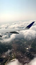 An Airplane Has Just Taken Off From O'Hare International Airport And Is Flying High Above Suburban Chicago, Illinois, USA. Flying Above The Clouds With Views Of The City Grid.