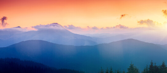 Canvas Print - A majestic view of the mountain ranges illuminated by the sunset.