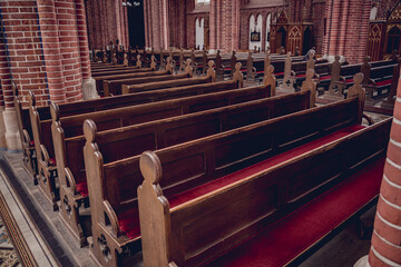 Wall Mural - Rows of church benches at the old european catholic church.