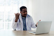 © KANGWANS - A black male doctor talks to his patients through teleconsultation.