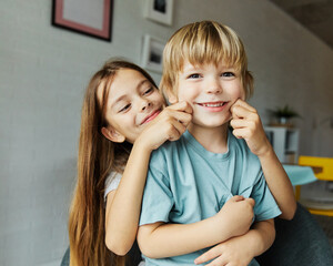 Wall Mural - child girl boy childhood kid brother sister love family together portrait fun happy joy happiness cute cheerful young