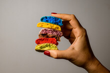 Set Of Six Tasty Multicolored Blanks Of Macaron Broken In Half In Female Hands