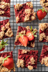 Strawberry granola bars on baking cooling rack . Delisious homemade oat squares for breakfast top view