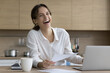 © fizkes - Portrait of happy freelancer woman sits at table holds sheets, laugh, look at cam, studying or working, pay domestic bills, feel satisfied with good results, personal finances management and paperwork