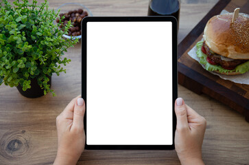 female hands holding computer tablet with isolated screen background burger