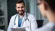 © Yeti Studio - Smiling male doctor communicating with a patient in his medical office
