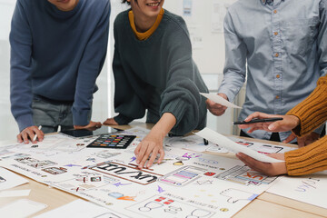 Close up ux developer and ui designer brainstorming interface wireframe design.Creative digital development agency