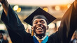 © annebel146 - Happy graduate. Happy African man in graduation gowns holdin, Celebration education graduation student succes learning concept Dark-skinned African-American graduate standing in victory pose