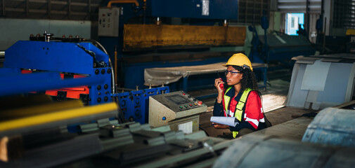 Industrial worker inspecting and check up machine at factory machines.Technician working in metal sheet at industry. Foreman checking Material or Machine.