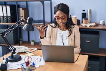 Canvas Print - Young african american woman call center agent having video call at office