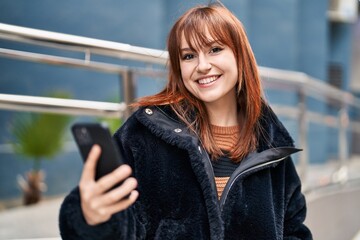 Poster - Young woman smiling confident using smartphone at street