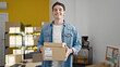 © Krakenimages.com - Young hispanic man ecommerce business worker holding packages at office