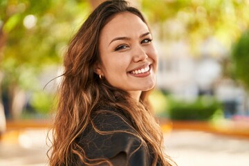 young beautiful hispanic woman smiling confident standing at park