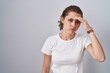 © Krakenimages.com - Beautiful brunette woman standing over isolated background worried and stressed about a problem with hand on forehead, nervous and anxious for crisis