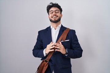 Poster - Hispanic man with beard wearing business clothes hands together and fingers crossed smiling relaxed and cheerful. success and optimistic