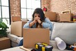 © Krakenimages.com - Young beautiful plus size woman stressed sitting on sofa at new home